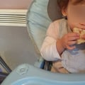 Olivia, avec les deux mains, mange sa brioche